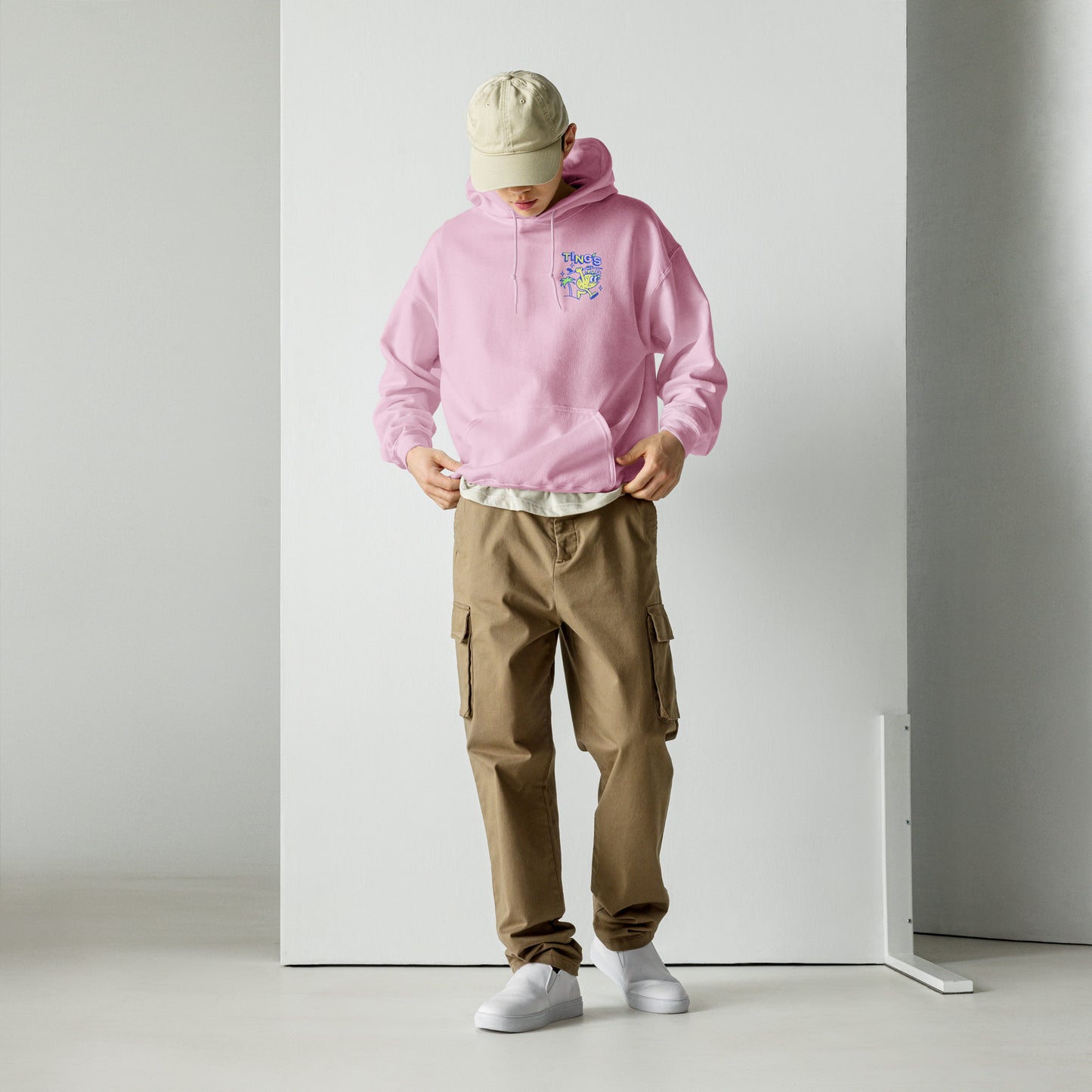 Male model wearing Ting's pink unisex hoodie with Ting's logo on front