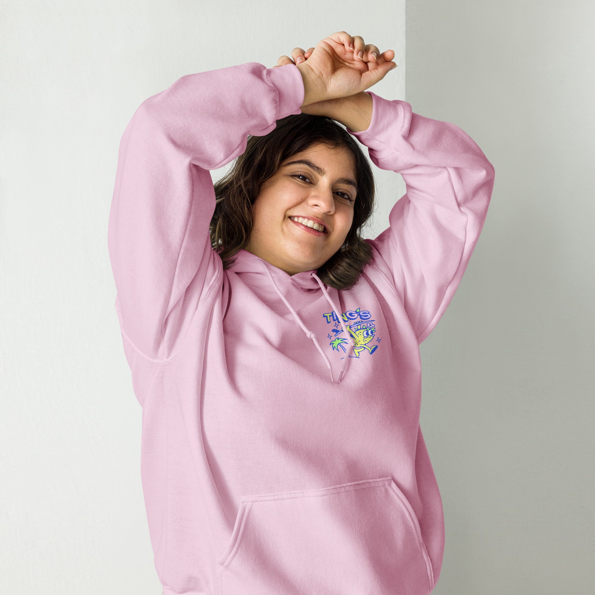 Female model wearing Ting's pink unisex hoodie with Ting's logo on front